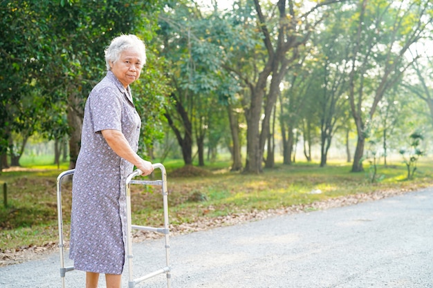 Asiatique senior ou âgée vieille dame patiente marche avec walker dans le parc