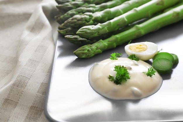 Asperges avec sauce sur gros plan de plaque