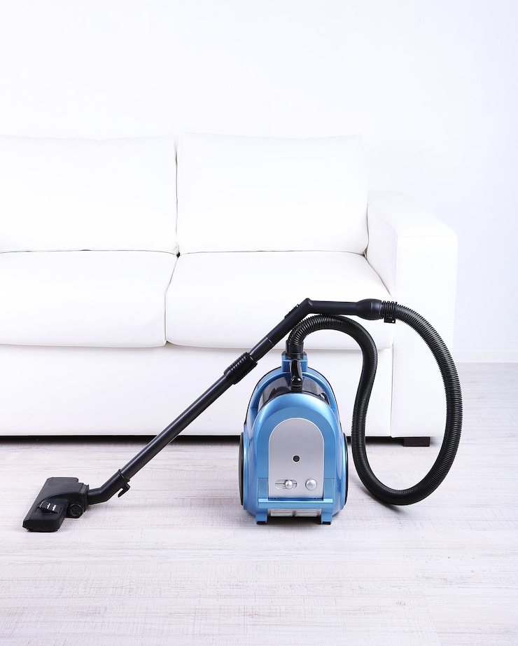 Photo un aspirateur pour ranger le salon.