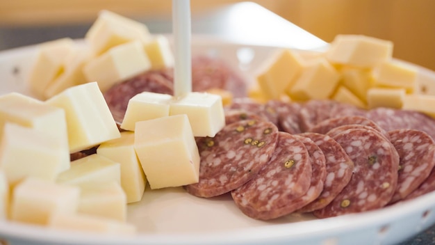 Assiette d'apéritif avec craquelins, salami et fromage.