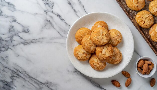 une assiette blanche de biscuits d'amande chinois sur une table en marbre