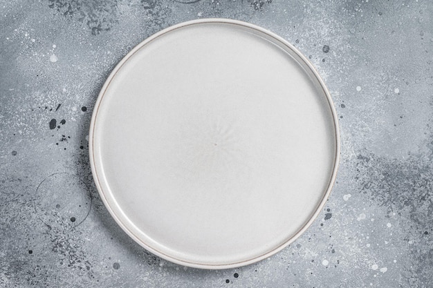 Assiette blanche vide sur la table Cuisson des aliments et fond de saine alimentation Fond gris Vue de dessus Espace de copie