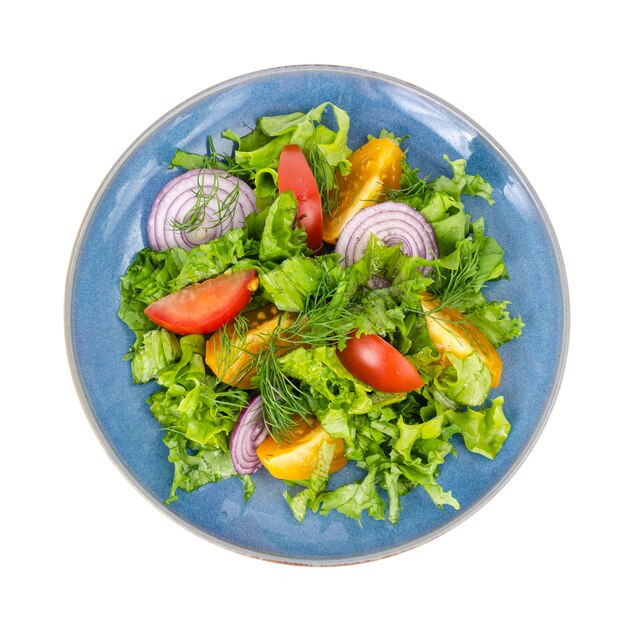 Assiette bleue avec vue de dessus de salade gros plan