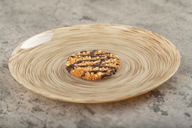 Assiette en céramique de biscuits à l'avoine glacée sur table en pierre.