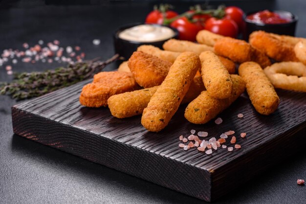 Assiette de collations bâtonnets de fromage pépite de poulet rondelles d'oignon mélange de collations et de sauces