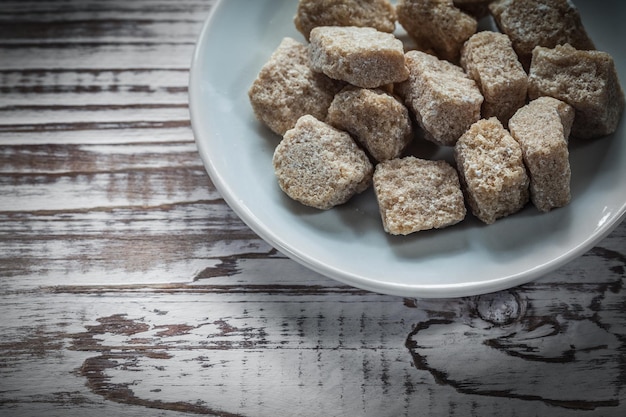 Assiette de cubes de sucre vintage sur planche de bois