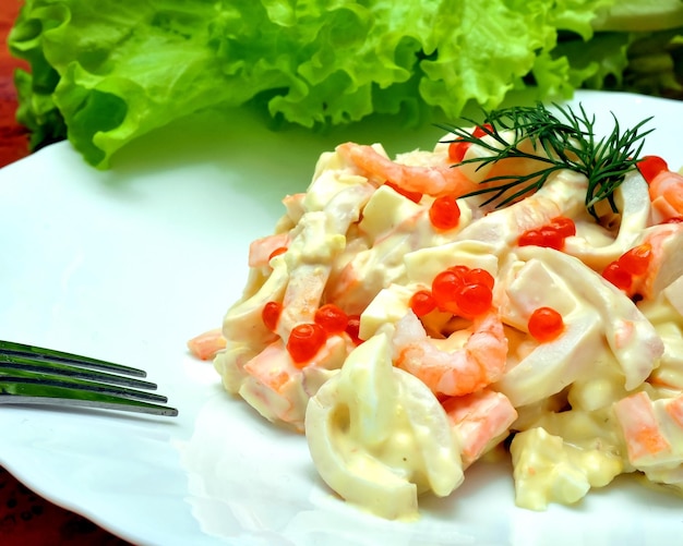 Une assiette de nourriture avec une fourchette et un morceau de laitue dessus.