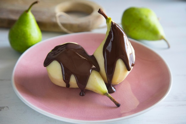 Une assiette de poires avec du chocolat dessus