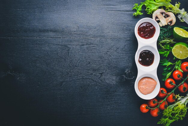 Assortiment de sauces épices et légumes Sur un fond en bois Vue de dessus Espace libre pour le texte