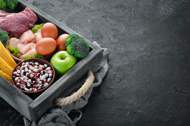 Assortiment de sources de protéines saines et d'aliments de musculation Viande filet de poulet brocoli haricots fromage oeufs blé Sur un fond de pierre