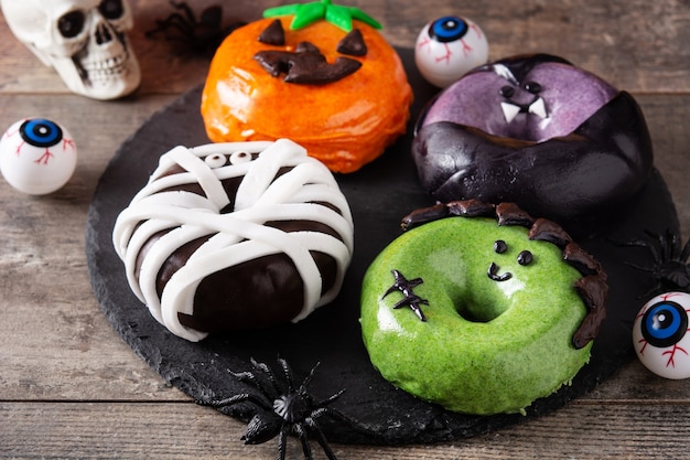 Assortmen de beignets d'Halloween sur table en bois