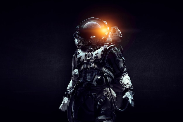 Astronaute en costume sur fond noir. Concept de technologie spatiale