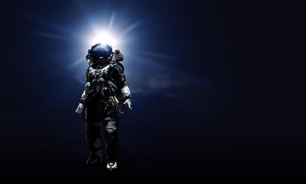 Astronaute en costume sur fond noir. Concept de technologie spatiale