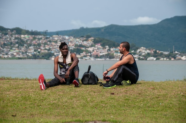 Athlète masculin africain un jour d'été pratiquant une activité physique avec son ami arabe dans le parc