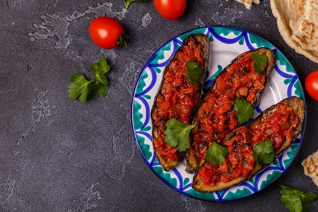 Aubergines au four avec tomates, oignon, ail et persil. Vue de dessus