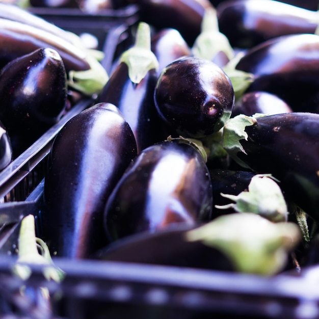 Des aubergines violettes fraîches sur un comptoir de marché de rue en Italie