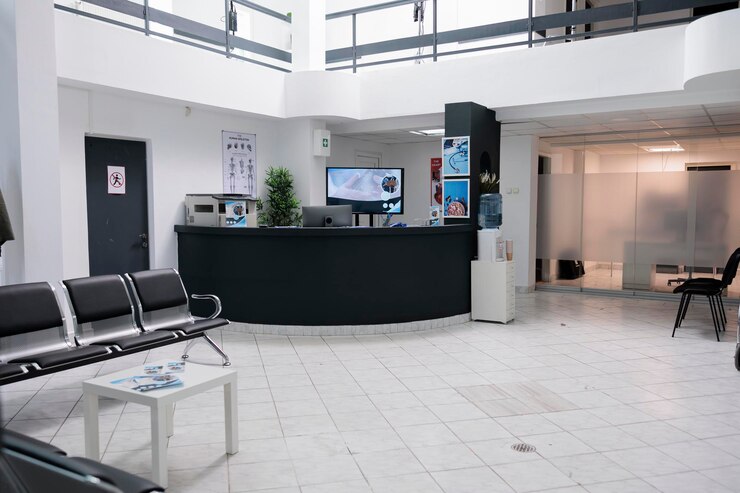 Photo aucune personne dans la zone d'attente pour les patients avec rendez-vous chez le médecin dans une clinique de soins de santé moderne dans un hôpital privé. salle d'attente vide avec réception avec dépliants promotionnels.