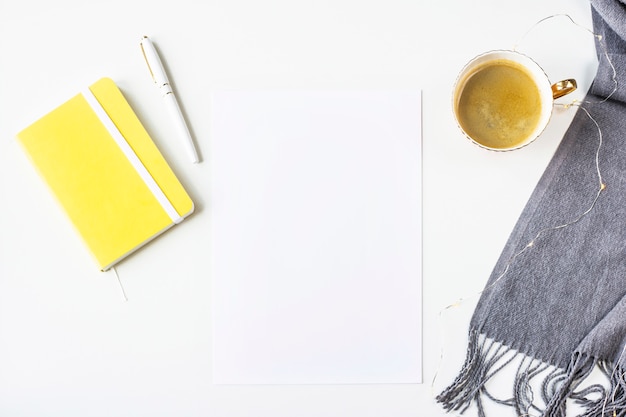 Automne maquette sur une table blanche à côté d&#39;une écharpe, bloc-notes jaune