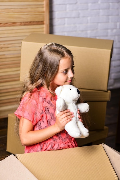 Une autre bonne raison de louer votre maison achat d'une nouvelle habitation petite fille heureuse avec jouet ours réparation de chambre nouvel appartement enfant heureux boîte en carton boîtes en carton déménagement dans une nouvelle maison