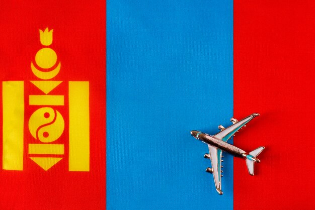 Avion au-dessus du drapeau du concept de voyage de la Mongolie