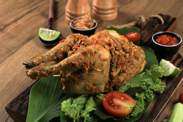 Ayam Betutu. Poulet rôti balinais farci aux feuilles de manioc.