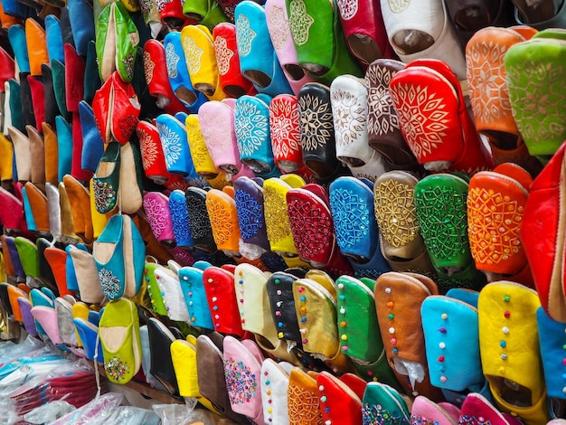 Photo babouches colorées faites à la main en cuir exposées au marché traditionnel du souk au maroc
