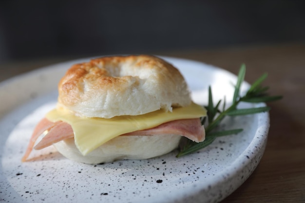 Bagel jambon fromage en gros plan sur fond de bois dans un café