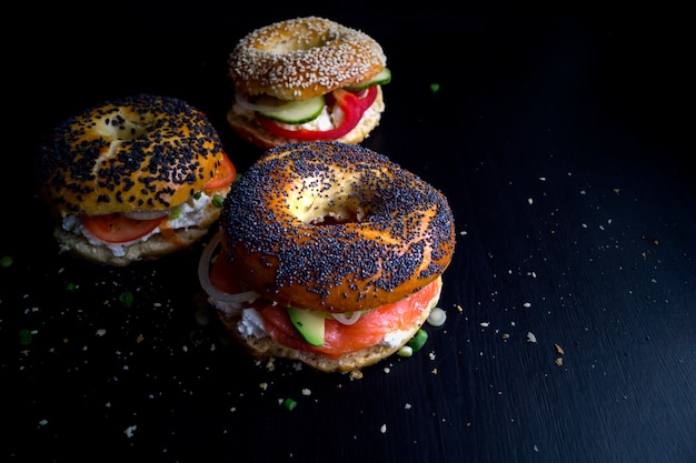 Bagels au fromage à la crème et saumon fumé sur fond noir