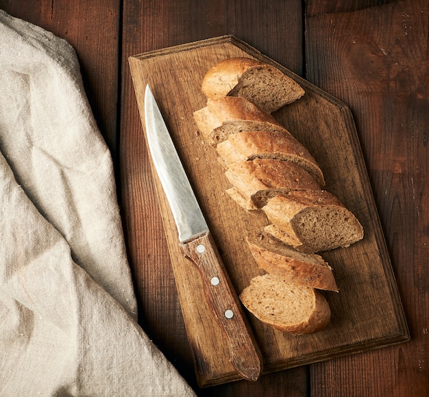 Baguette de farine de seigle en tranches sur une planche à découper en bois