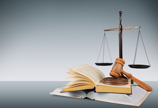 Balances et livres de justice et marteau en bois sur table. Notion de justice