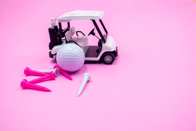 Photo la balle de golf et la voiturette sont en rose avec des tees