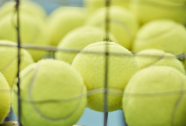 Photo balle de tennis en gros plan et panier pour l'entraînement ou le sport pour l'exercice cardio ou servir pour le jeu tournoi d'équipement sportif et gazon pour athlète professionnel ou santé pour l'entraînement en plein air ou le fitness