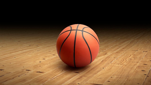 Un ballon de basket avec un fond sombre sur un plancher de gym en bois franc