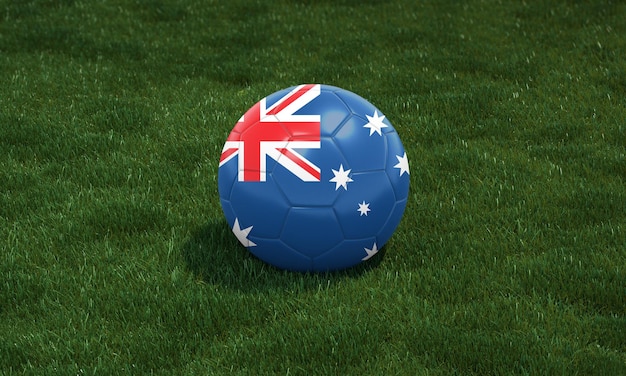 Ballon de football aux couleurs du drapeau australien dans un stade sur fond d'herbes vertes