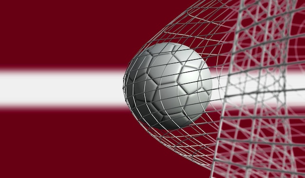 Le ballon de football marque un but dans un filet contre le rendu 3D du drapeau de la Lettonie