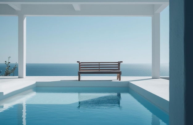 Un banc est à côté d'une piscine avec l'océan en arrière-plan.