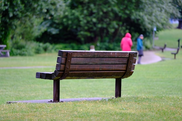 Un banc vide sur un champ herbeux dans un parc