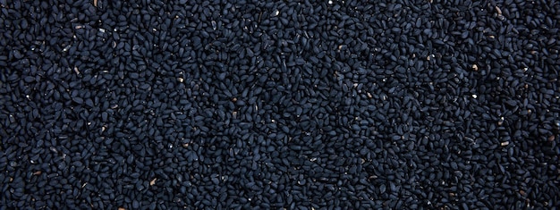 Photo bannière de fond plein cadre de couleur noire de graines de sésame crues