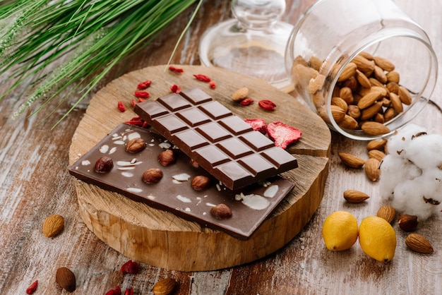 Barre sucrée de chocolat aux fruits et noix sur le fond en bois