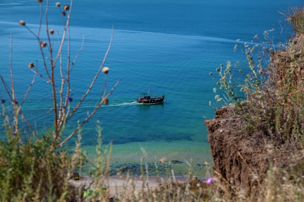 Le bateau de pêche longe la côte de la mer Noire