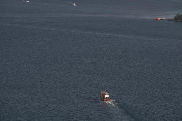 Le bateau de pêche navigue sur une surface de mer bleue