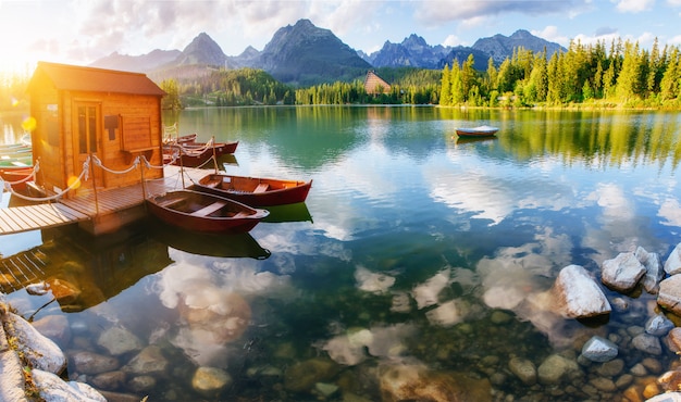 Bateau sur le quai entouré de montagnes. Fantastic Shtrbske Pleso