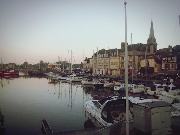 Photo des bateaux amarrés au port contre des bâtiments de la ville