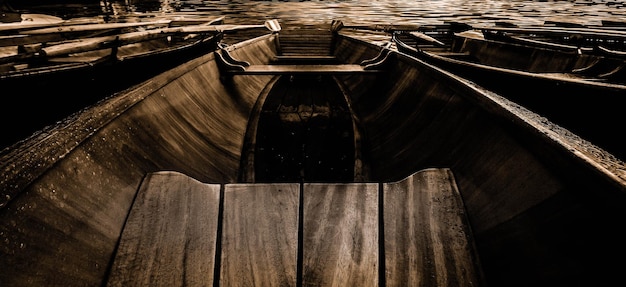 Photo des bateaux en bois vides amarrés sur une rivière.