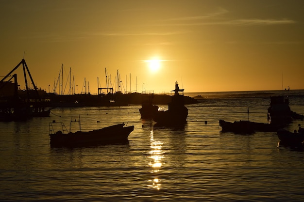 Bateaux de pêche à la jetée de la ville au coucher du soleil sur le port d'Antofagasta Chili