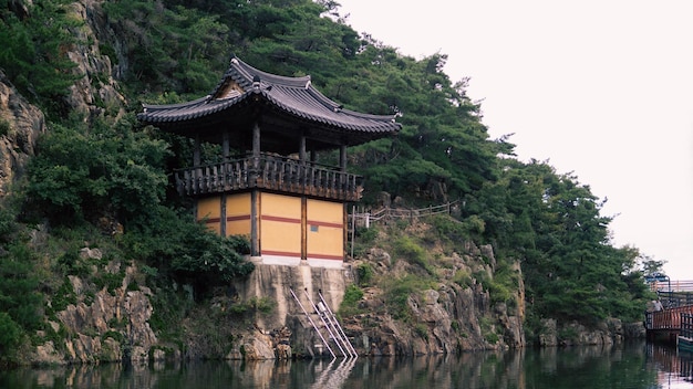 Bâtiment asiatique entre un lac et des arbres