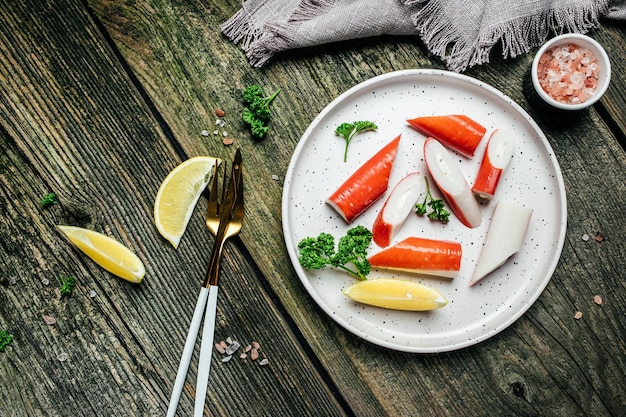 Bâtonnets de crabe sur fond rustique en bois. bannière, menu, lieu de recette pour le texte, vue de dessus.