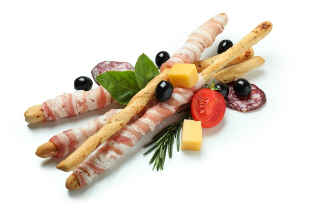 Bâtonnets de grissini avec du bacon et des collations isolé sur fond blanc