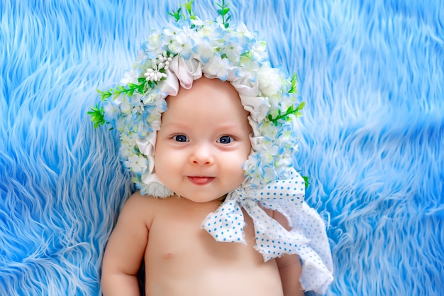 Beau bébé dans un chapeau fait de fleurs