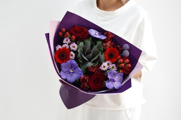Beau bouquet de fleurs dans les mains d'une femme photo pour carte postale et catalogue d'un fleuriste en ligne livraison de fleurs fraîches
